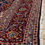 Thumbnail: This Persian Kashan rug features a striking medallion motif in beautiful red and blue colors.