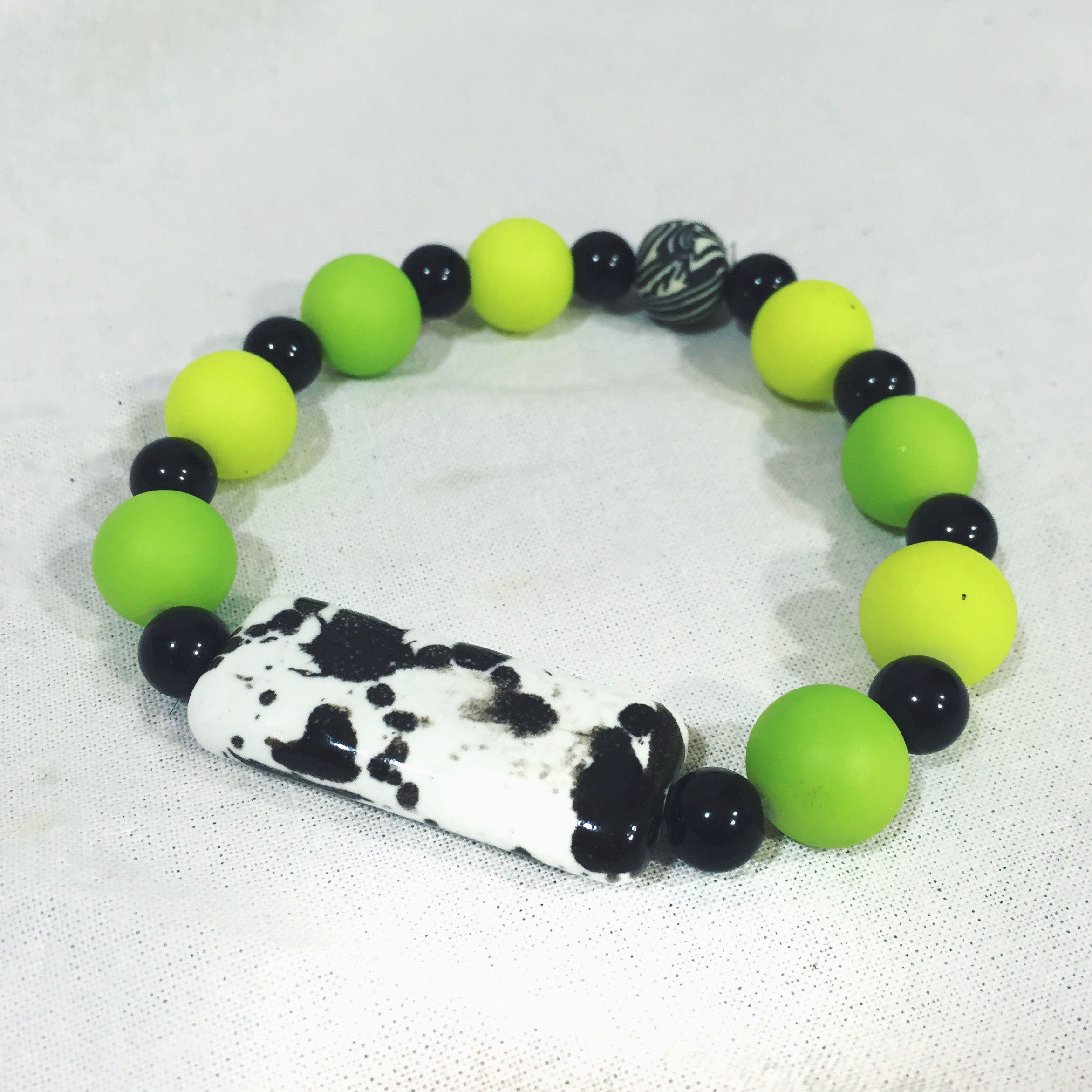 "Dalmatian Doll" Green Beaded Stretch Bracelet