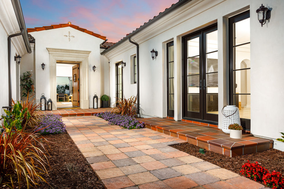 a brick walkway leads to the front door of a house
