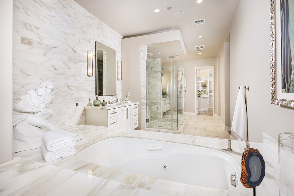 a bathroom with a tub and a walk in shower