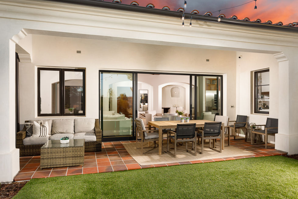 a patio with a table and chairs and a couch