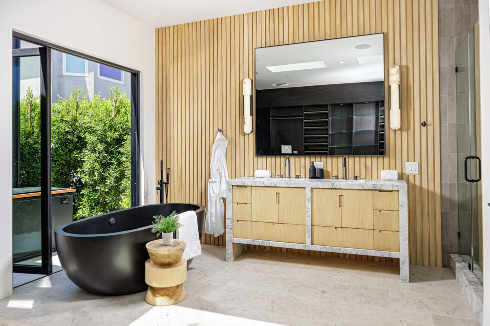 a bathroom with a black tub and two sinks