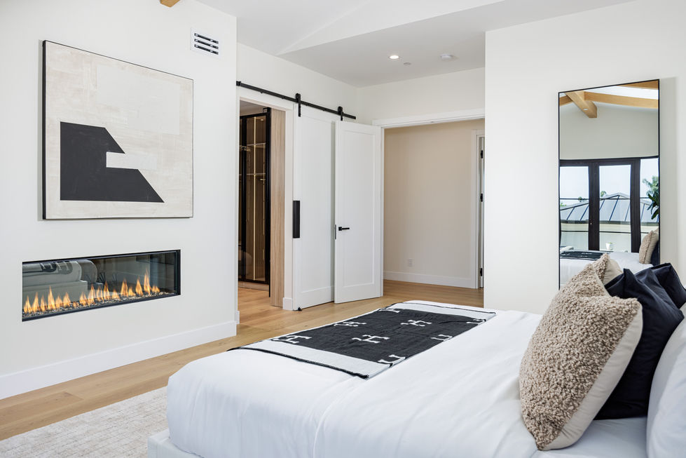 a bedroom with a sliding barn door and a fireplace