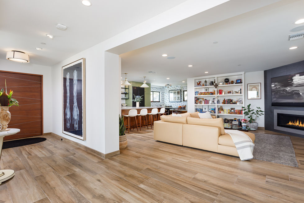 a living room with a couch and a picture on the wall