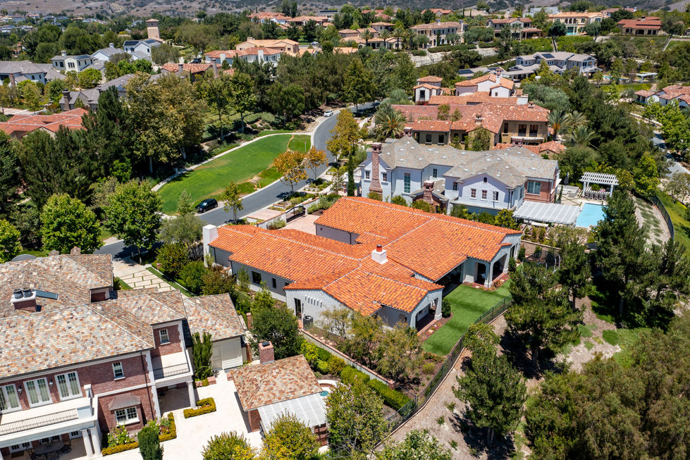 an aerial view of a house with a red tile roof