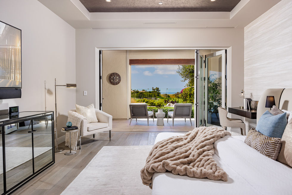 a bedroom with a clock on the wall above the bed