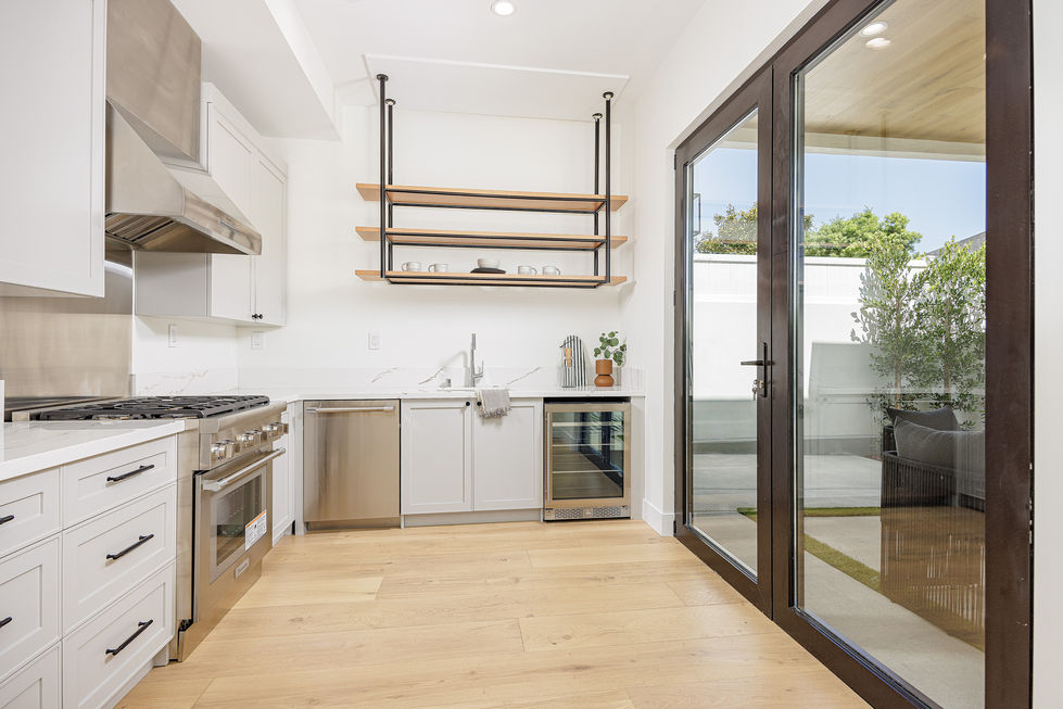 a kitchen with stainless steel appliances and white cabinets