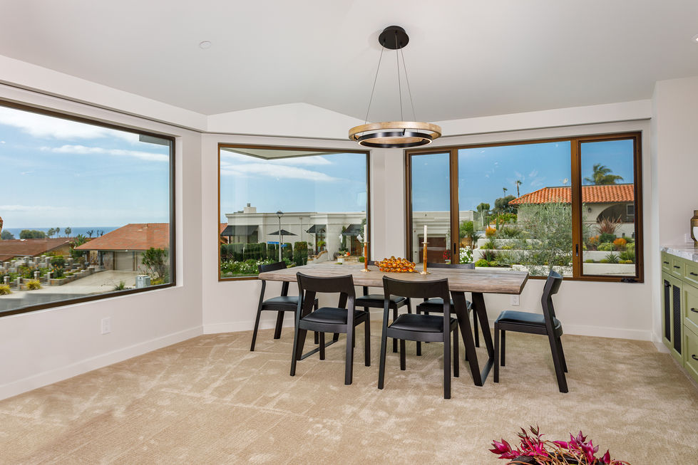 a dining room with a table and chairs and a large window