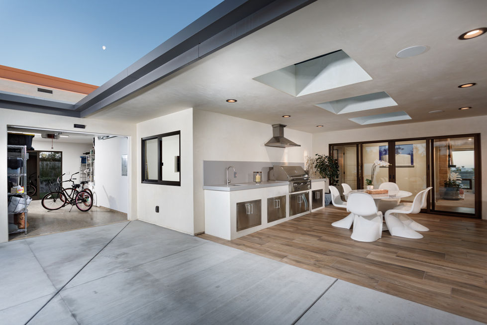 a kitchen with stainless steel cabinets and a grill