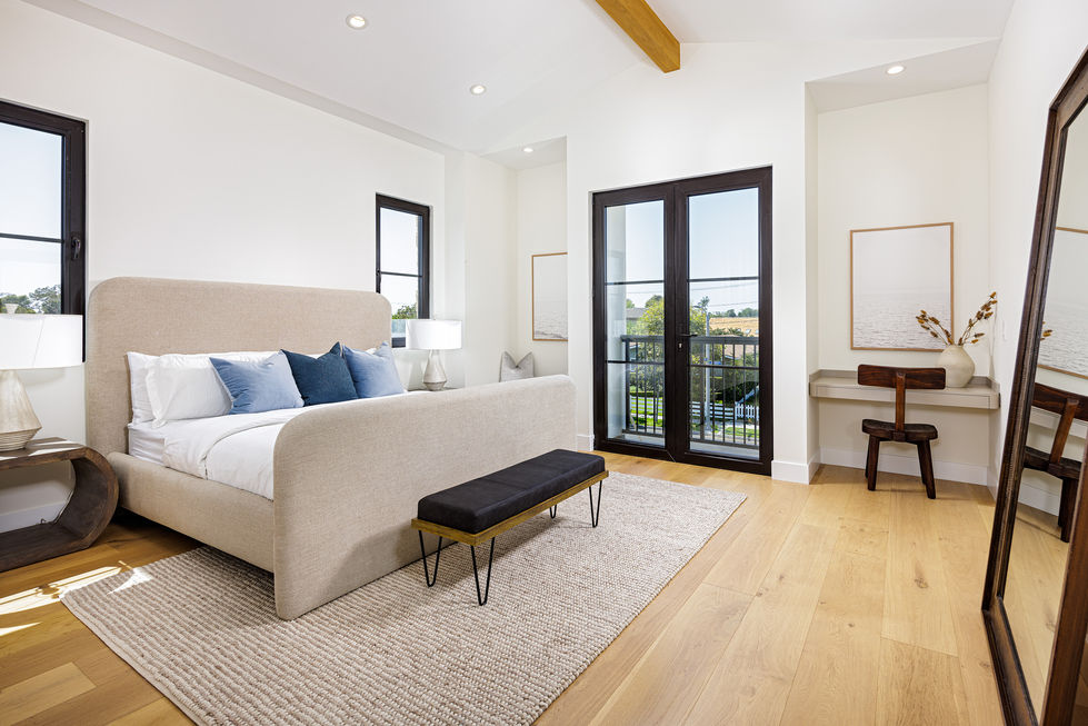 a bedroom with a large bed and a bench