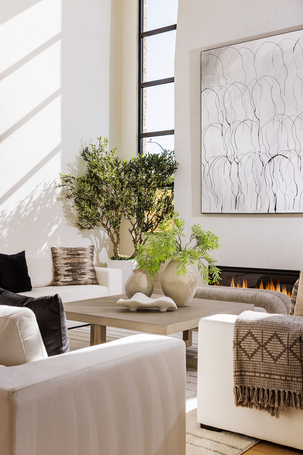 living room detail with sun racking through a window and across a wall