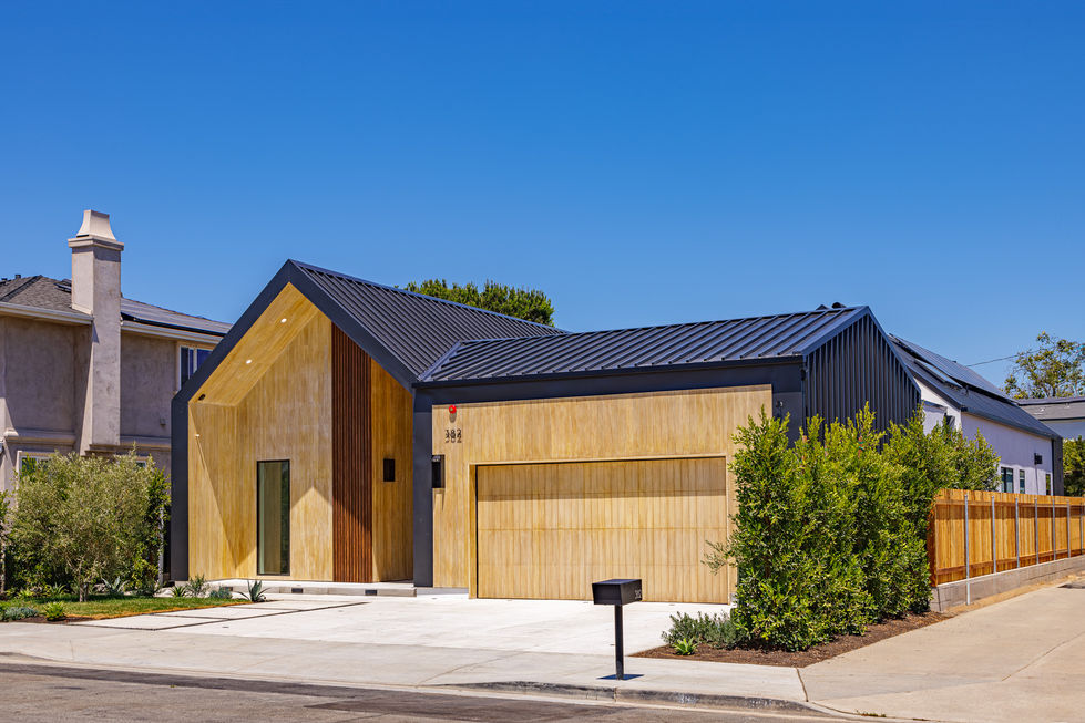 a house with a black roof has the number 392 on it