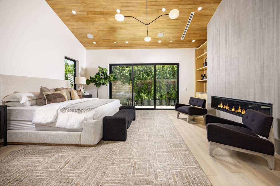 a bedroom with a large bed and a fireplace