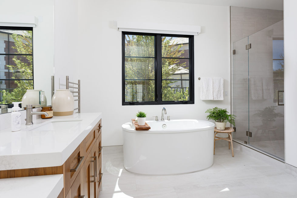 a bathtub in a bathroom with a black window