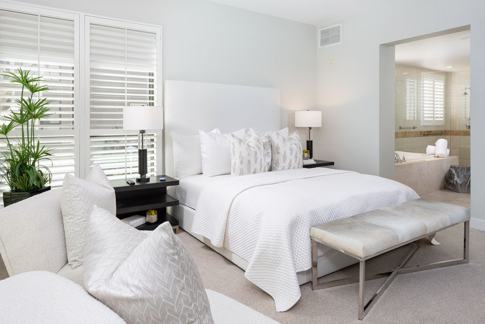 a bedroom with a king size bed and two lamps