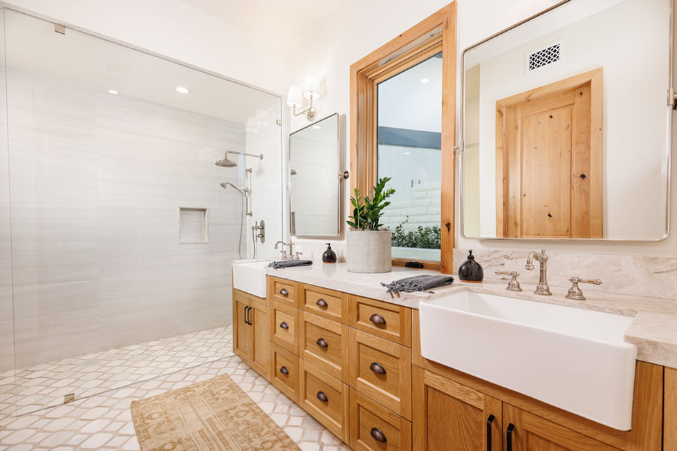 a bathroom with two sinks and two mirrors