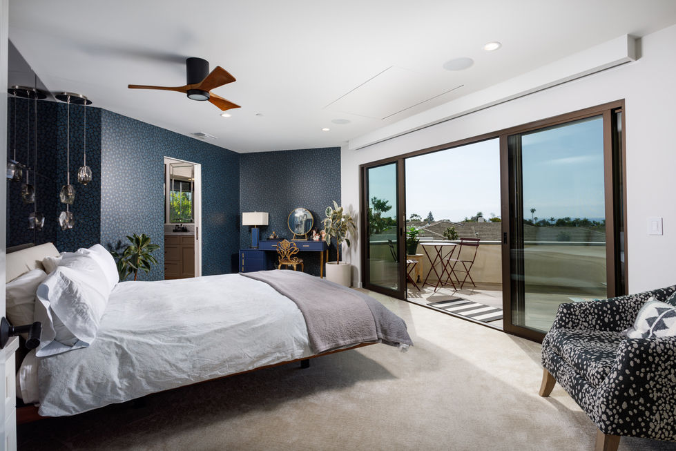 a bedroom with a large bed and a ceiling fan