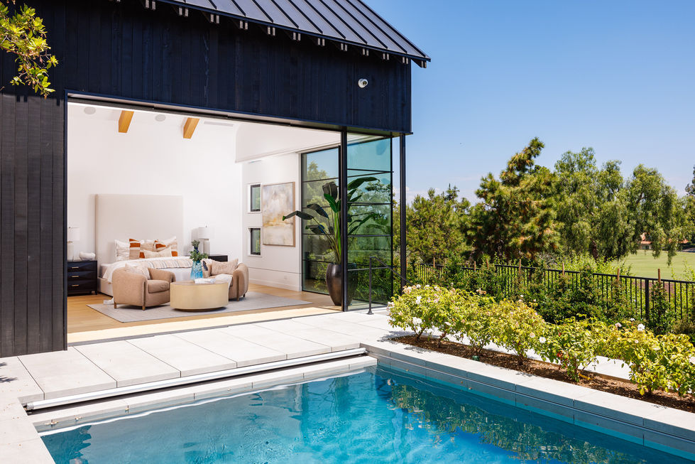 Primary bedroom with a swimming pool in front of it