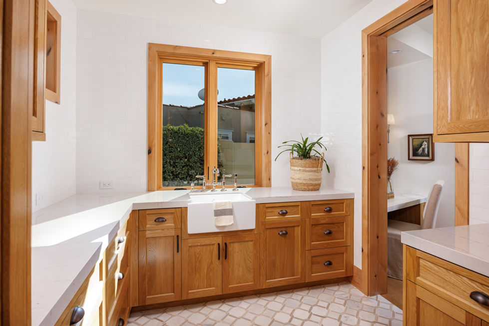a kitchen with wooden cabinets and a white sink