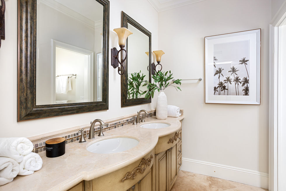 a bathroom with two sinks and two mirrors