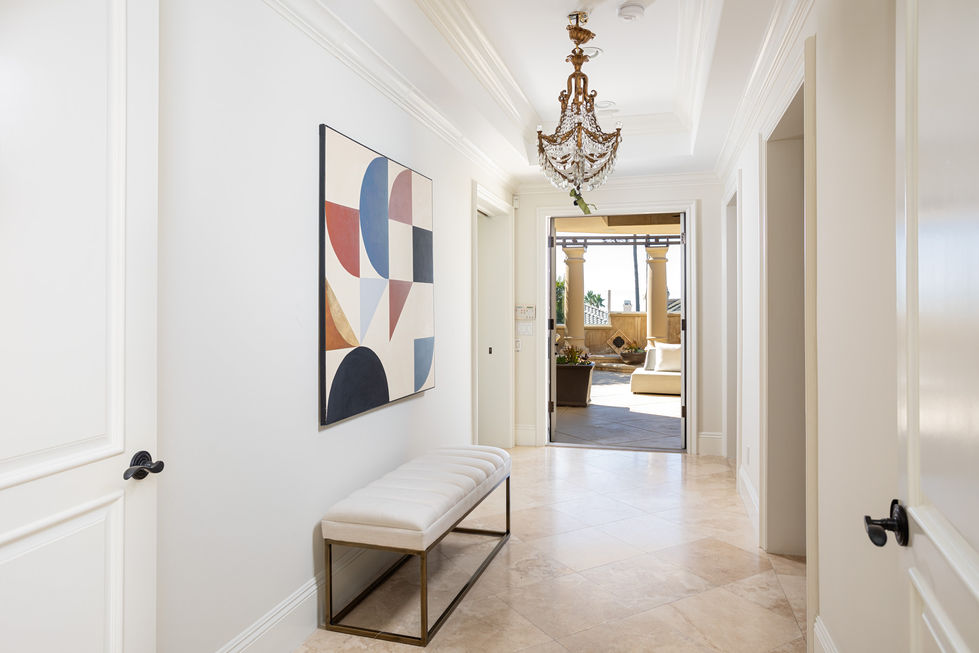 a hallway with a bench and a painting on the wall