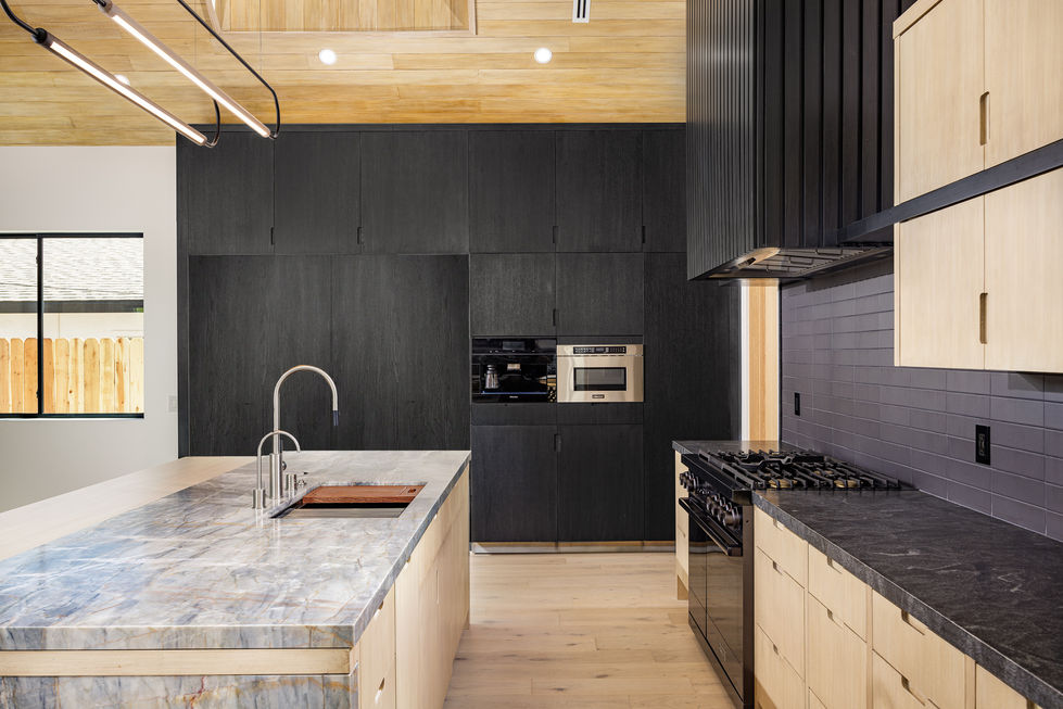 a kitchen with stainless steel appliances and black cabinets
