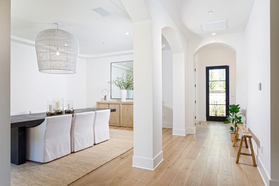 a dining room with a table and chairs and a mirror