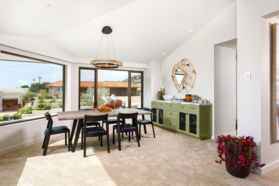 a dining room with a table and chairs and a green cabinet