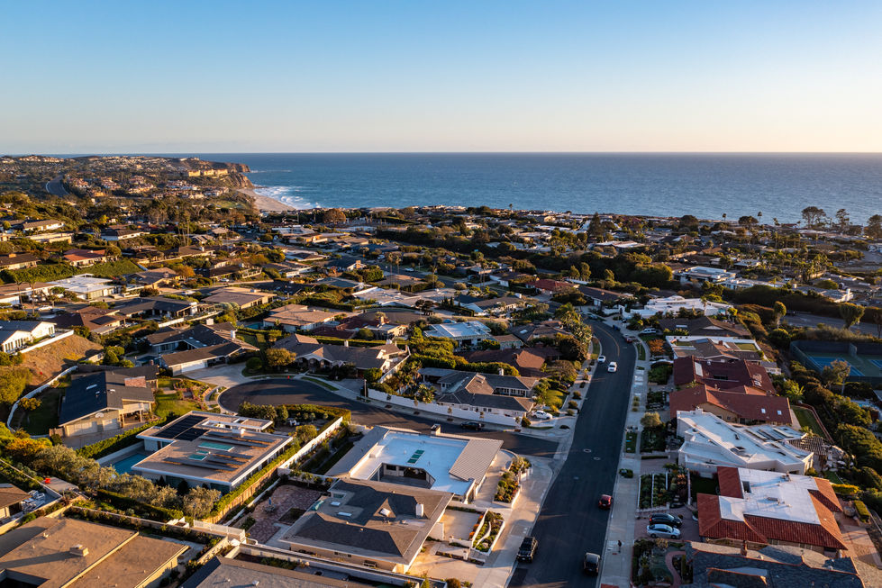 an aerial view of a residential area near the ocean