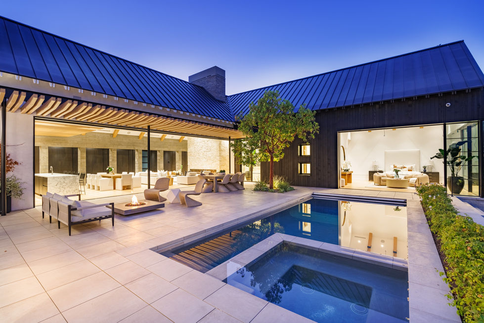 a large house with a swimming pool and a fire pit