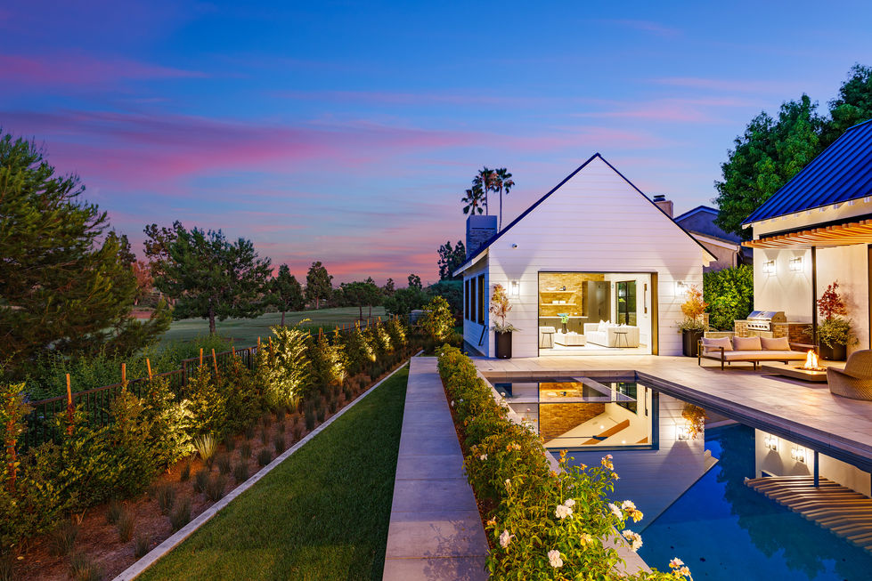 a house with a swimming pool in front of it