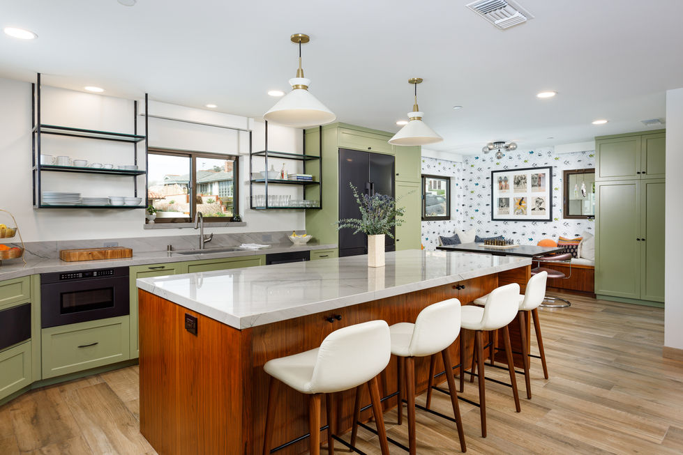 a kitchen with a large island and white stools