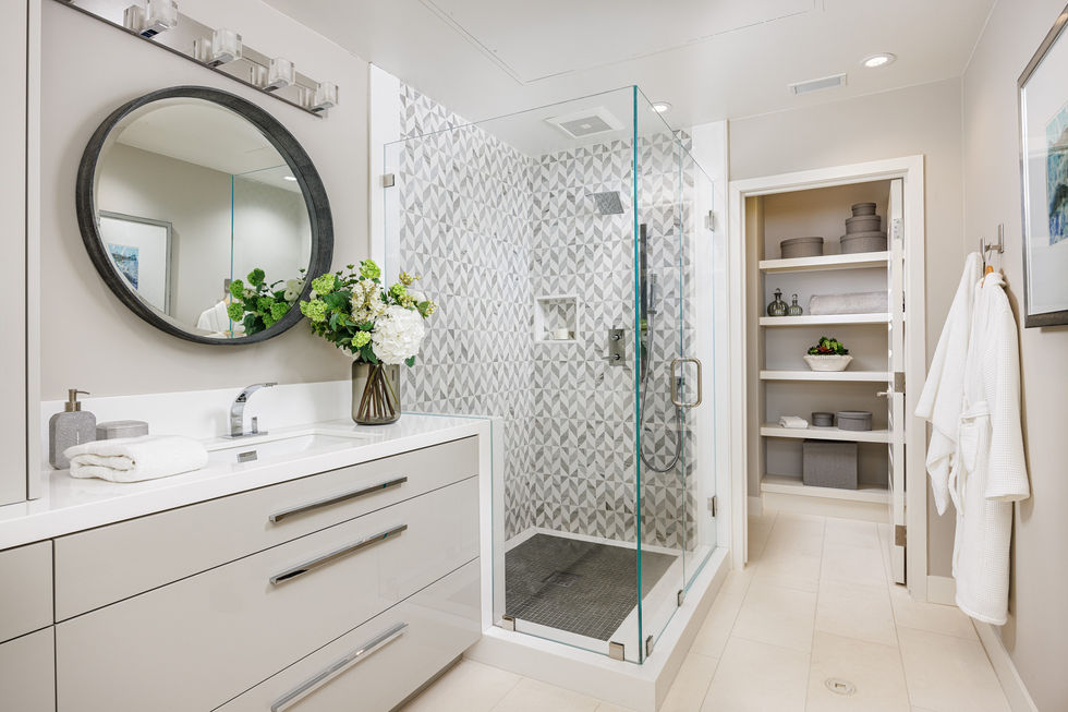 a bathroom with a walk in shower and a sink