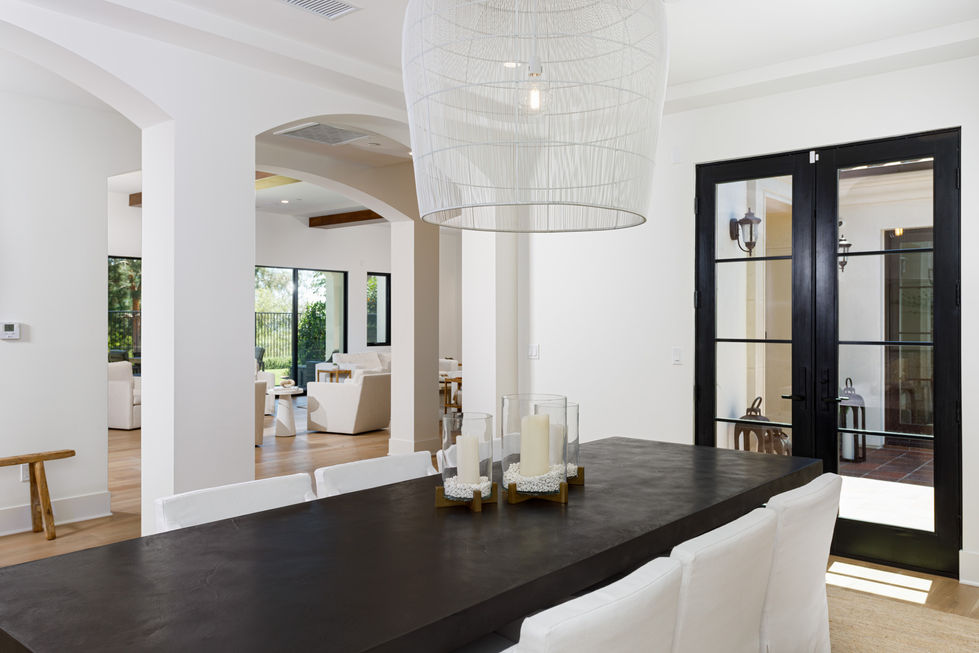 a dining room table with two candles on it
