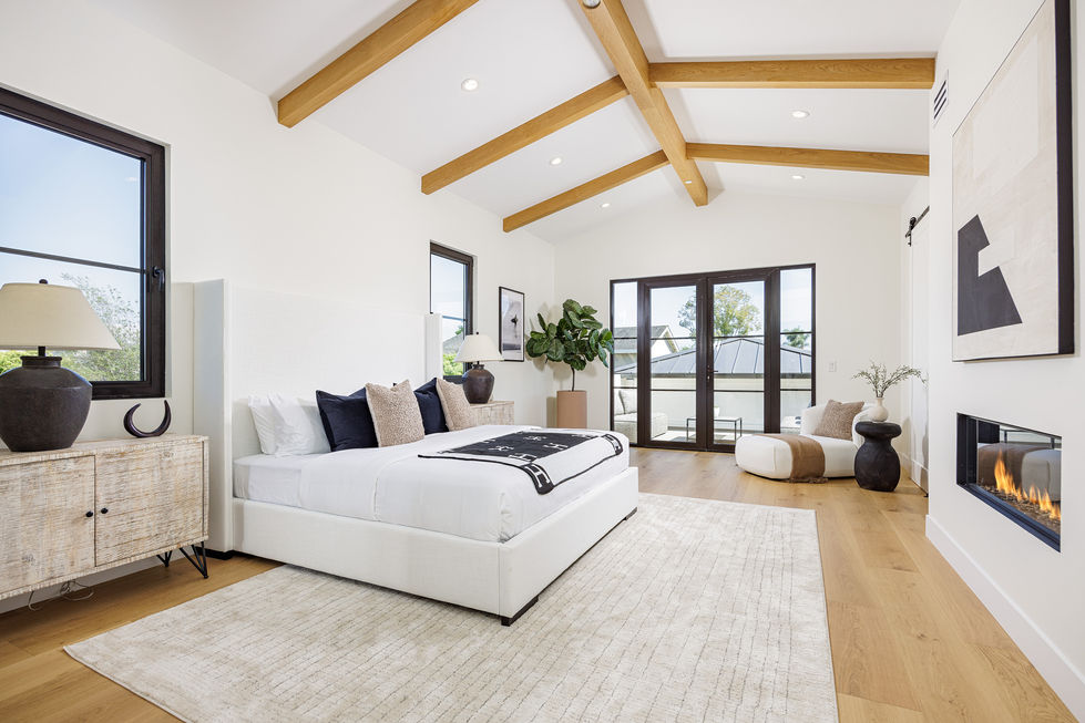 a bedroom with a large bed and a large window
