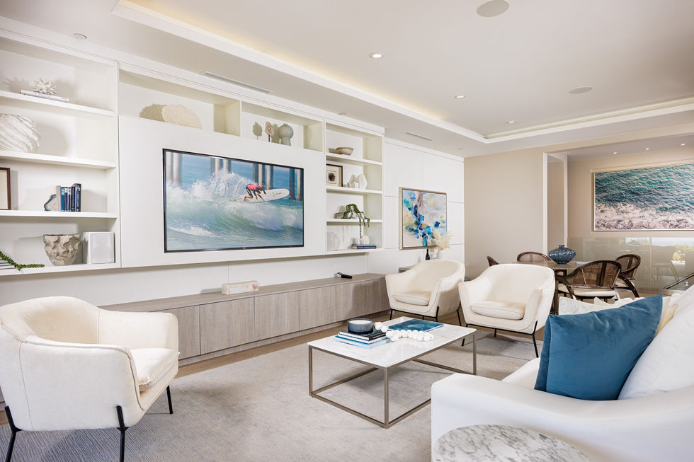 a living room with a flat screen tv showing a person on a surfboard