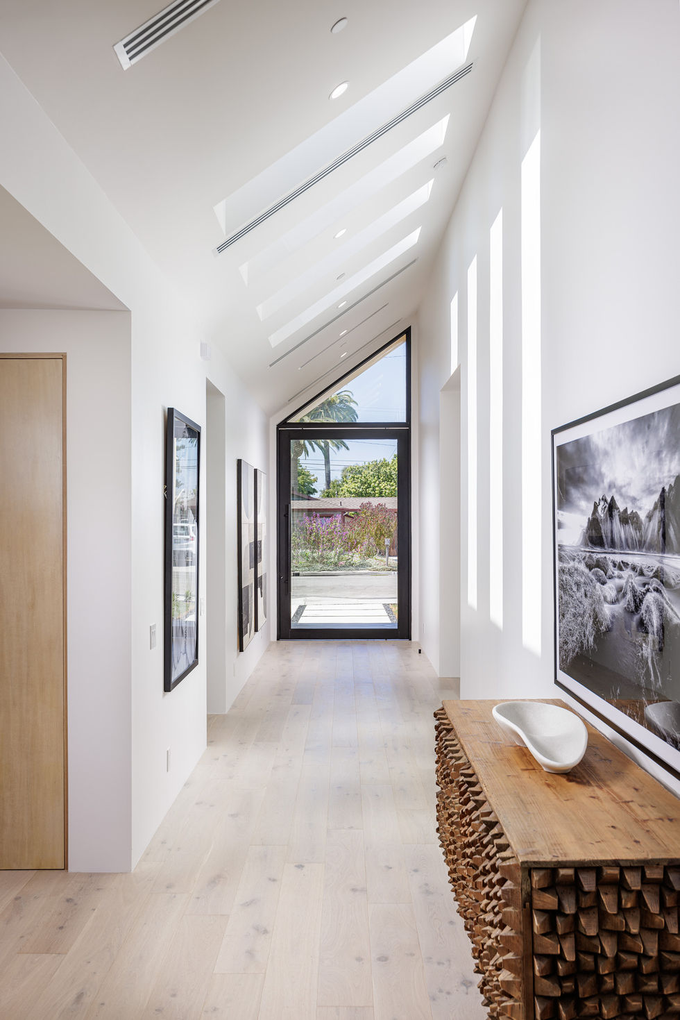 a hallway with a large window and a picture on the wall