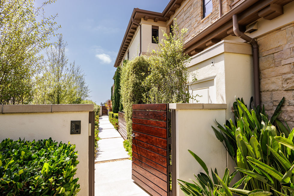 a house with a wooden gate leading to it