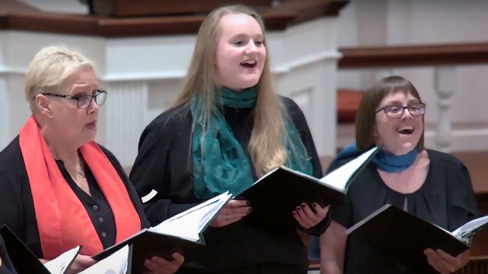 Three choir members singing with happy expressions