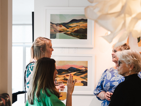 People talking at an art exhibition at AD Library