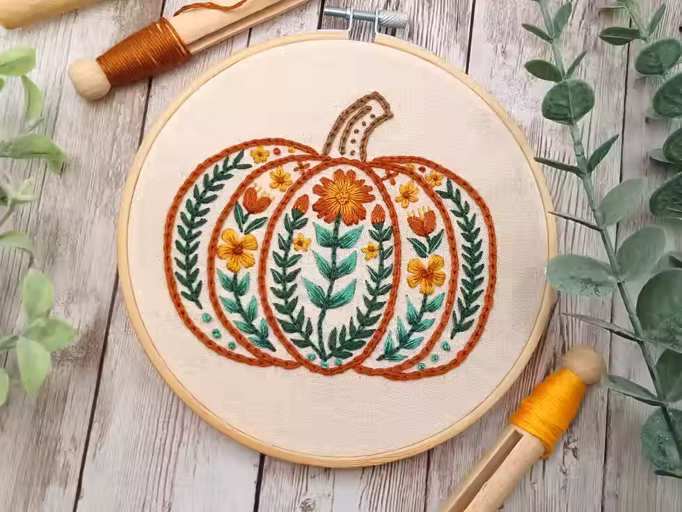 Autumn embroidery featuring pumpkin with decorative flowers