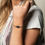 Thumbnail: Woman's wrist wearing black beaded bracelet