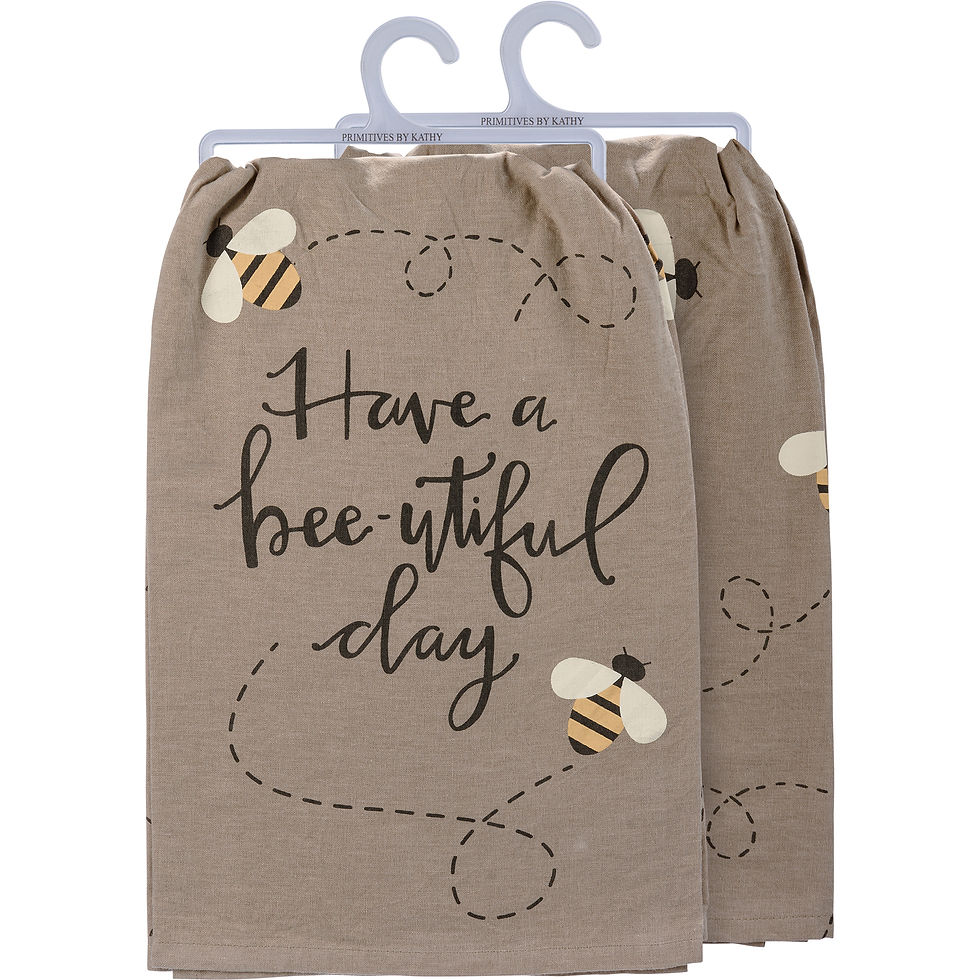Tan kitchen towels with bees and text: "Have a bee-utiful day"