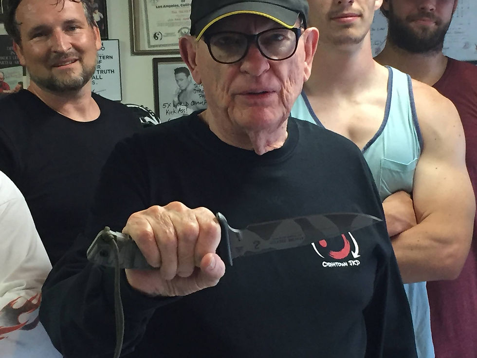 Tim Tackett holding the Apache Falcon Knife (TOPS Knives by Snake Blocker)