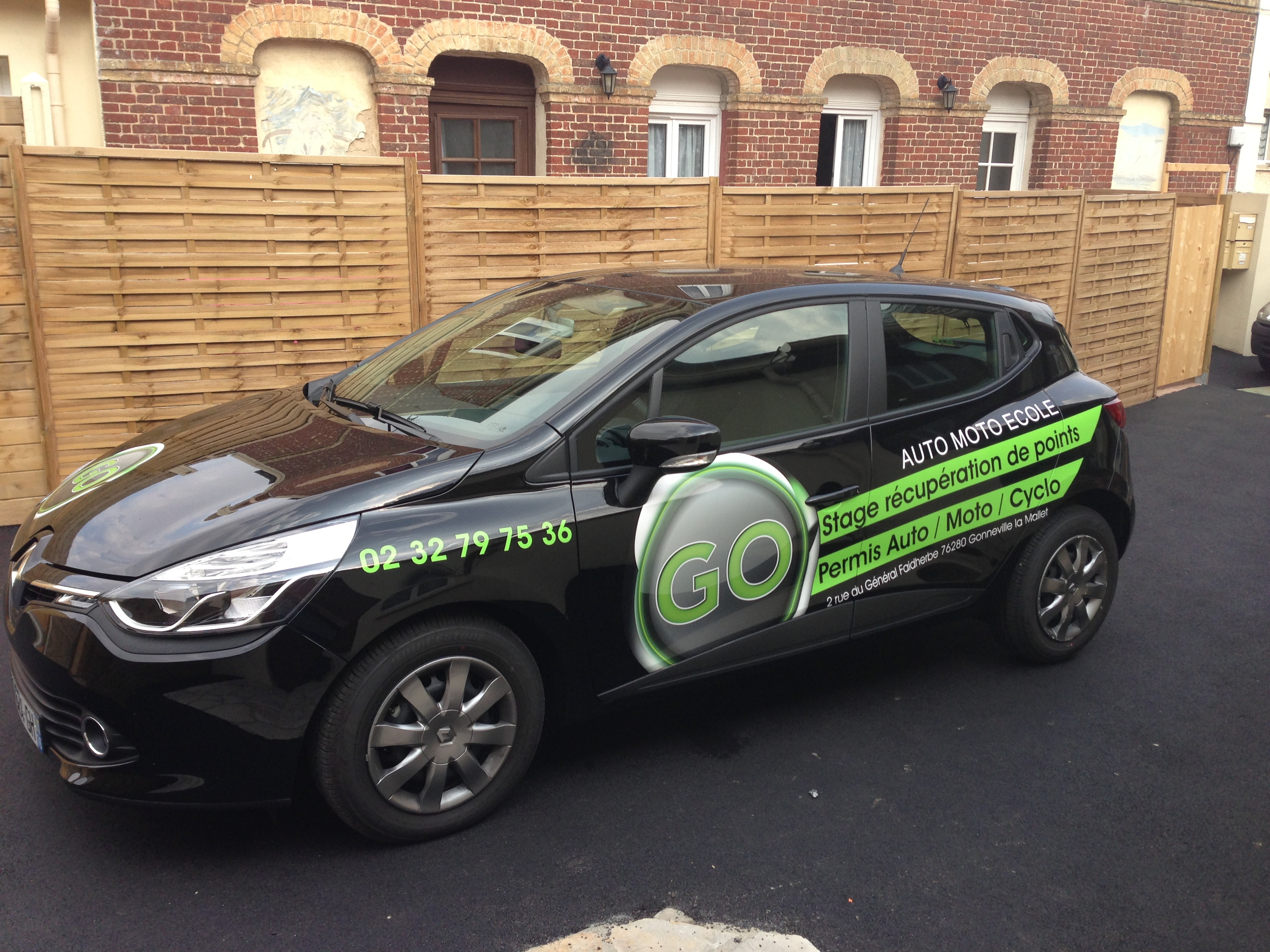 Marquage publicitaire sur Renault Clio noire pour l'auto-moto-école GO, réalisé par Peppergraphik au Havre