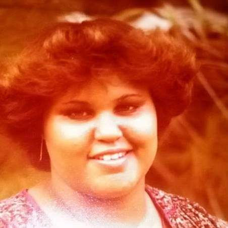 Outdoors, Heather Campbell smiles while wearing a patterned top.