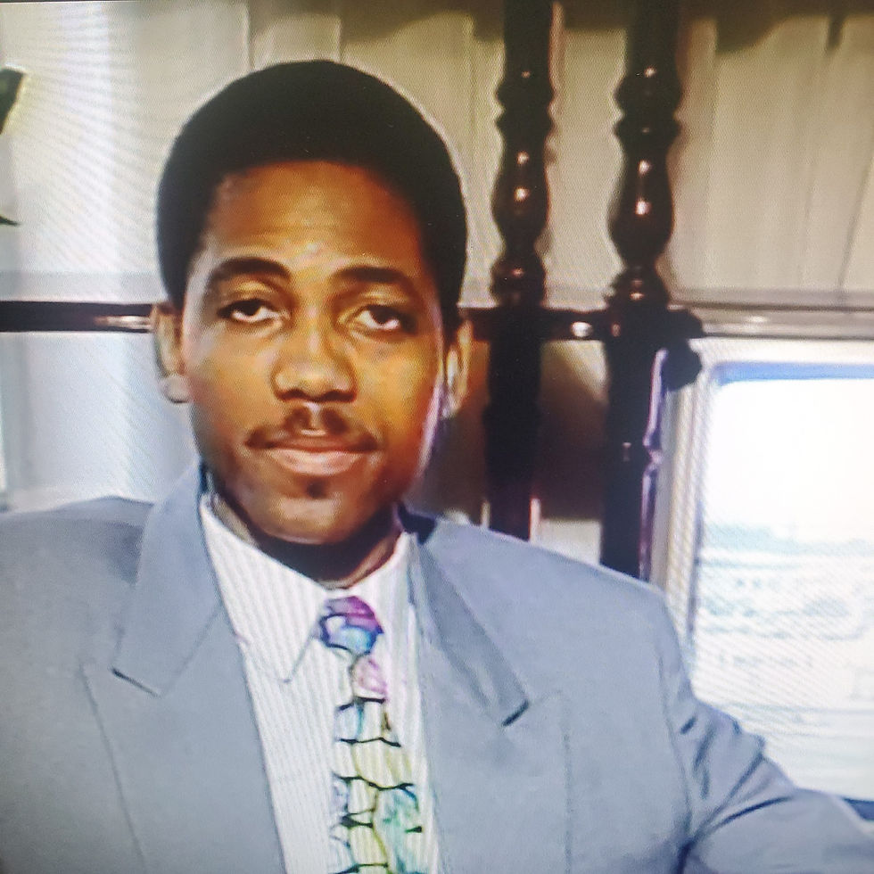 Patrick Anderson dressed in a gray suit with a colorful tie.
