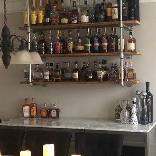 Reclaimed barnwood bar shelves with industrial metal brackets