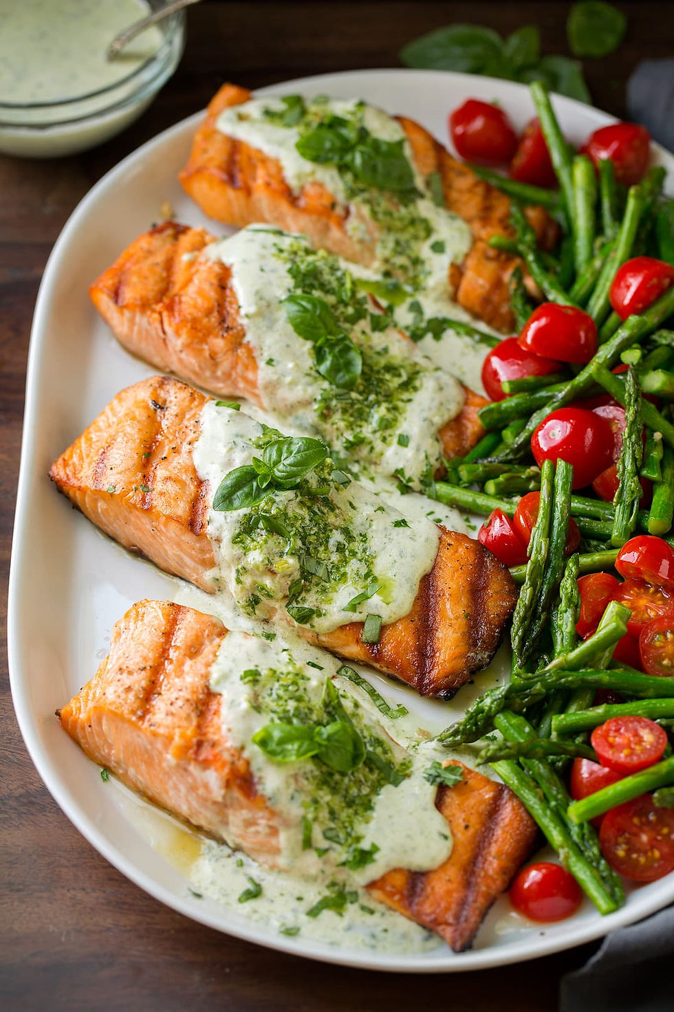 Grilled salmon with dill cream sauce and grilled vegetables