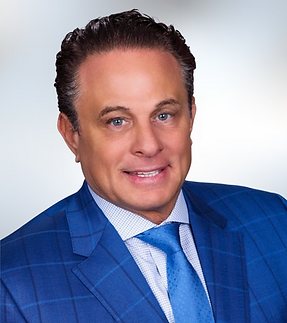 Female headshot with white shirt and dark hair up in bun